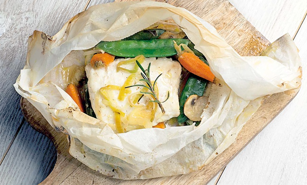 Cod and vegetables baked in a parchment paper