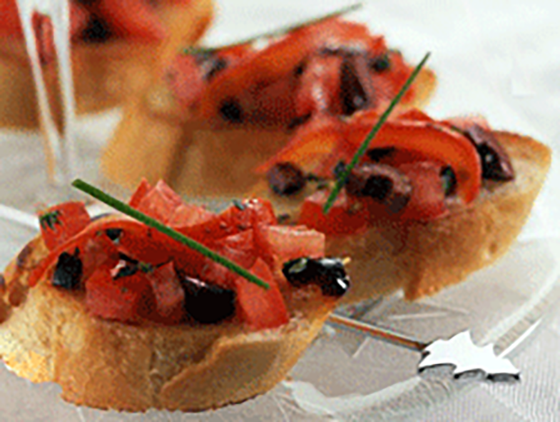 Crostini served topped with ham and olives