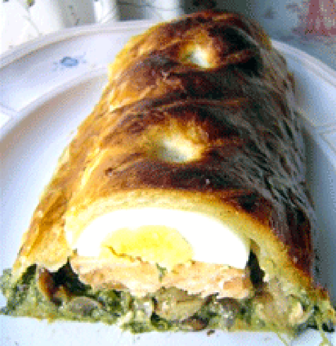 Baked Koulibaic sliced open to reveal the filling