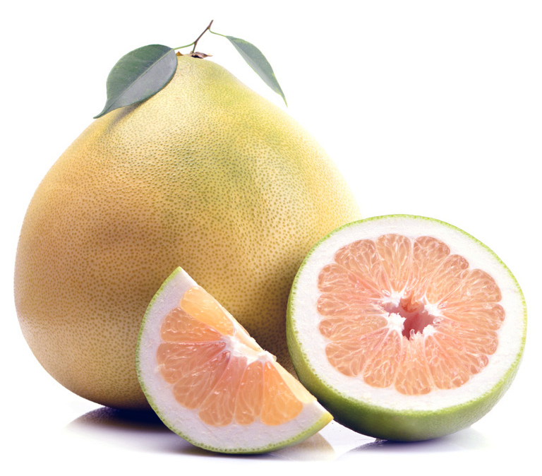 Whole pomelo and sliced fruit