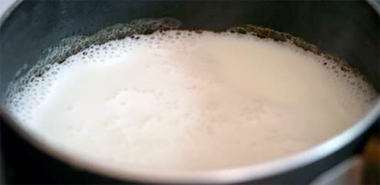 Milk heated in a saucepan to the scalding point