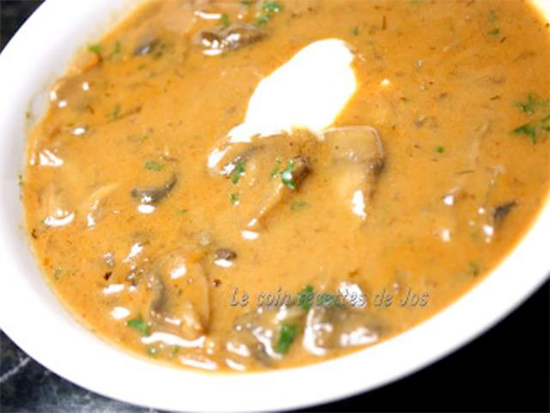 Soupe Hongroise. French paprika soup in a white bowl with yoghurt
