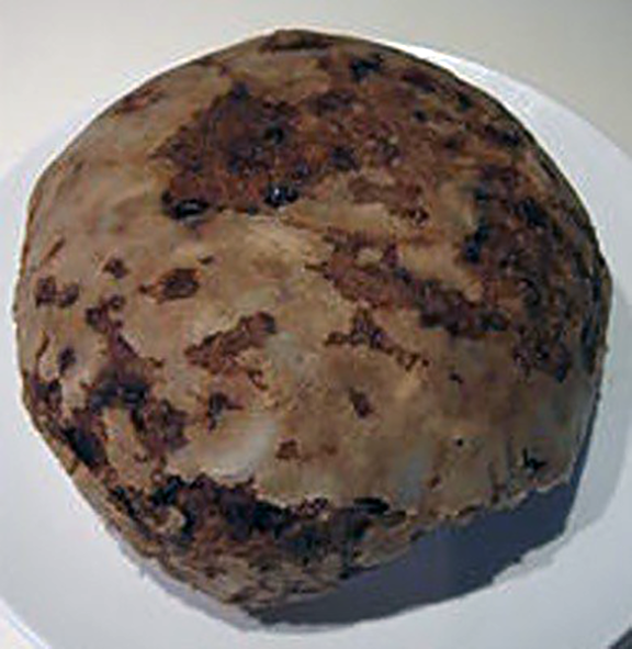 classic cannonball-style christmas pudding on a white plate
