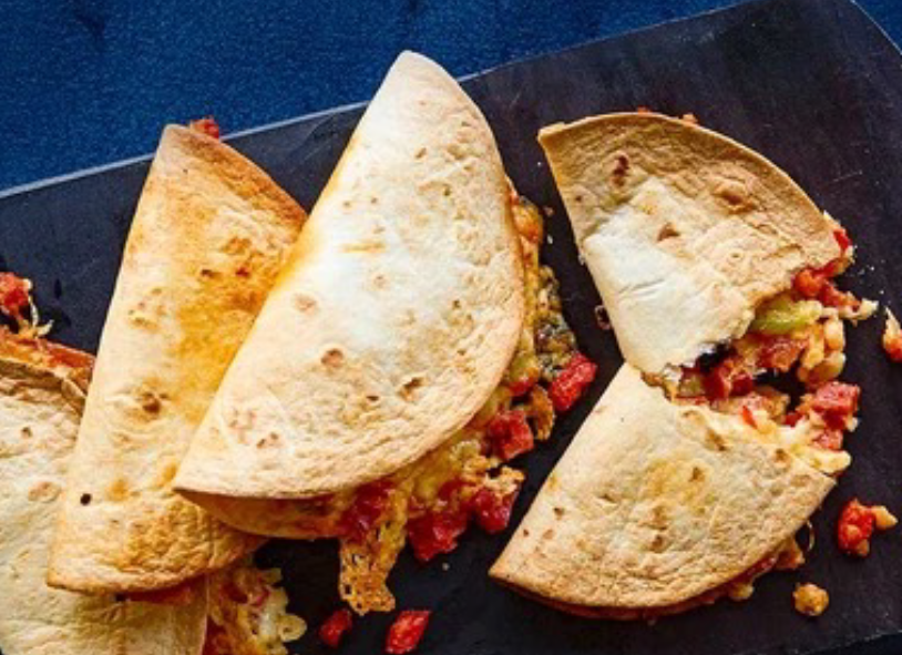 quesadillas with a cheese, chorizo, tomato, spring onion and chilli filling cooked in an air fryer and shown on a serving plate