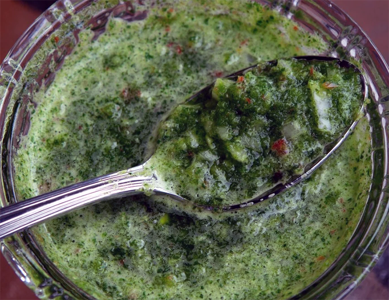 ají criollo Ecuadorian hot sauce in a glass bowl with a spoon