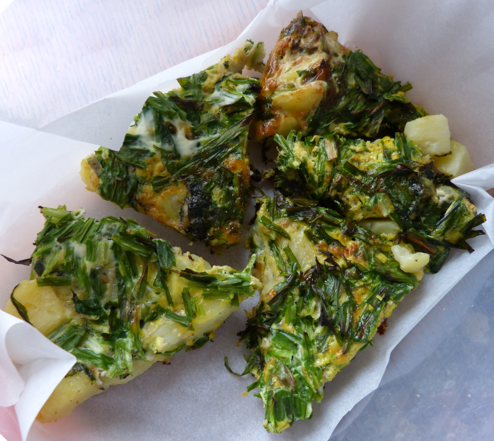 Wedges of Alexanders and Three Cornered Leek Frittata on sheets of kitchen paper