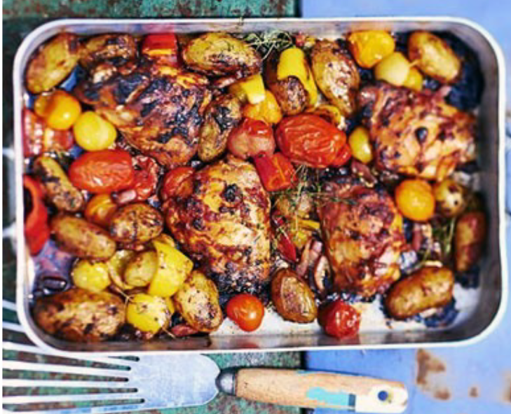 chicken and potatoes in a tomato and pancetta base baked in a roasting tin