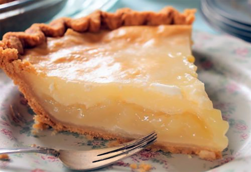 generous wedge of Amish lemon pie served on a plate with a fork