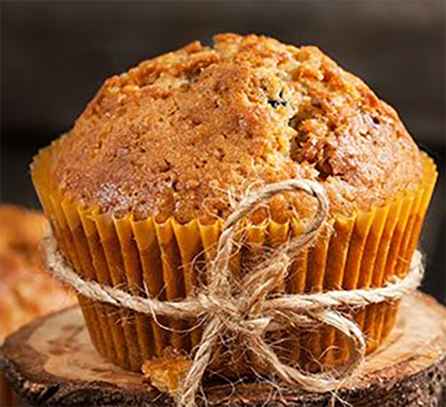 apple and tamarillo muffin in a paper case on a wooden block