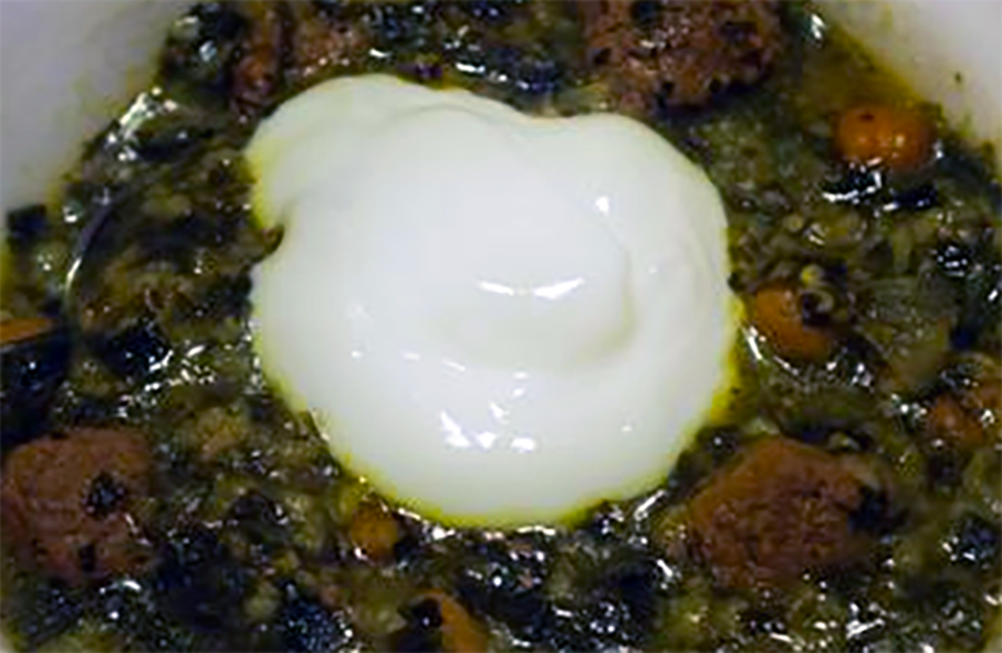 Ahseh Mast, Persian herb and yoghurt soup served in a bowl with a dollop of yoghurt to garnish