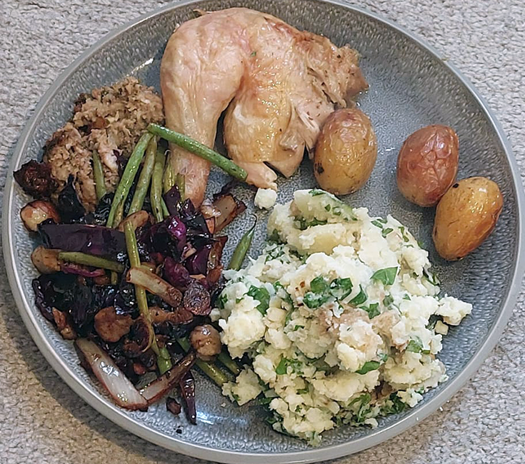 red cabbage with fine beans and chestnuts on a plate with stuffing, chicken leg, mash and roast potatoes