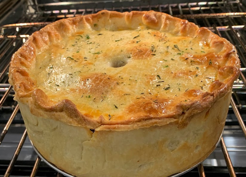raised hot water crust chicken pie in an oven