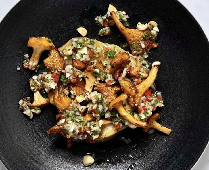 slice of baked celeriac topped with fried wild mushrooms and a cobnut relish