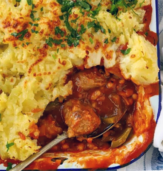 sausages and beans topped with cheese mash in a baking dish