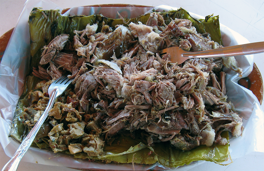 shredded barbacoa served on a cabbage leaf on a plate