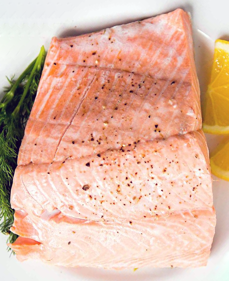 barbecue poached salmon served on a plate with dill and lemon