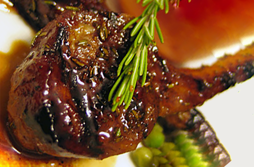 lamb chop barbecued with a redcurrant and mustard glaze garnished with a sprig of thyme