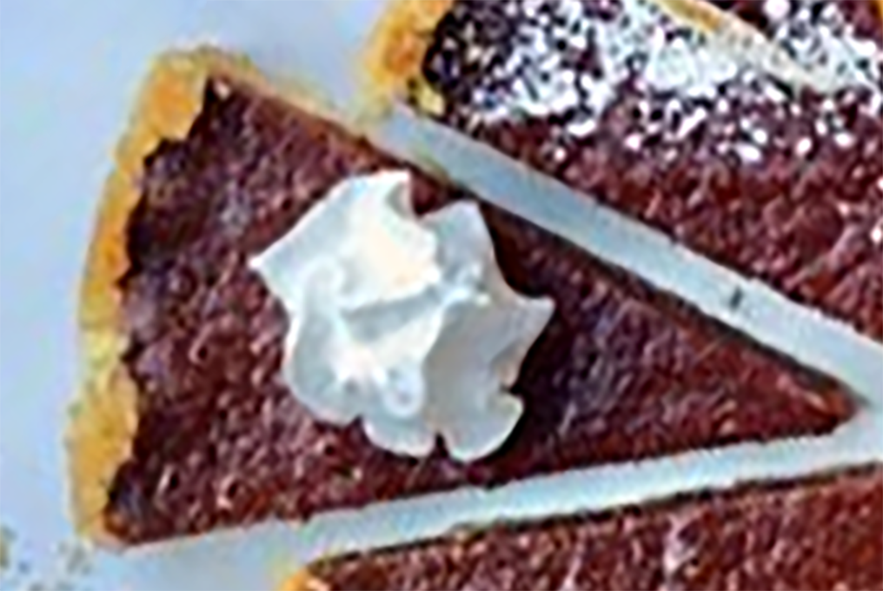 wedge of barberry tart garnished with a swirl of cream