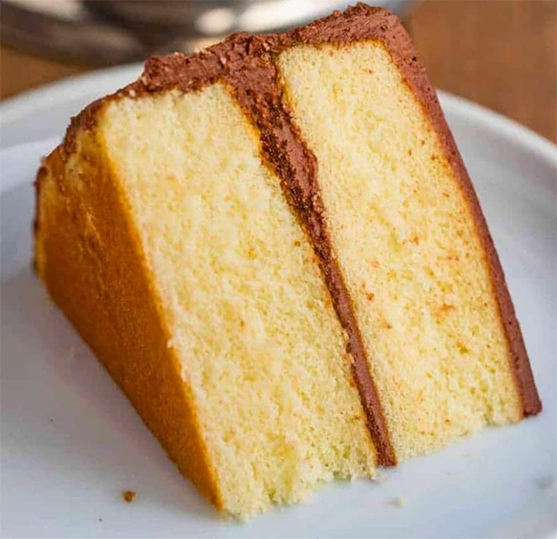 wedge of basic yellow cake mix cake with chocolate icing
