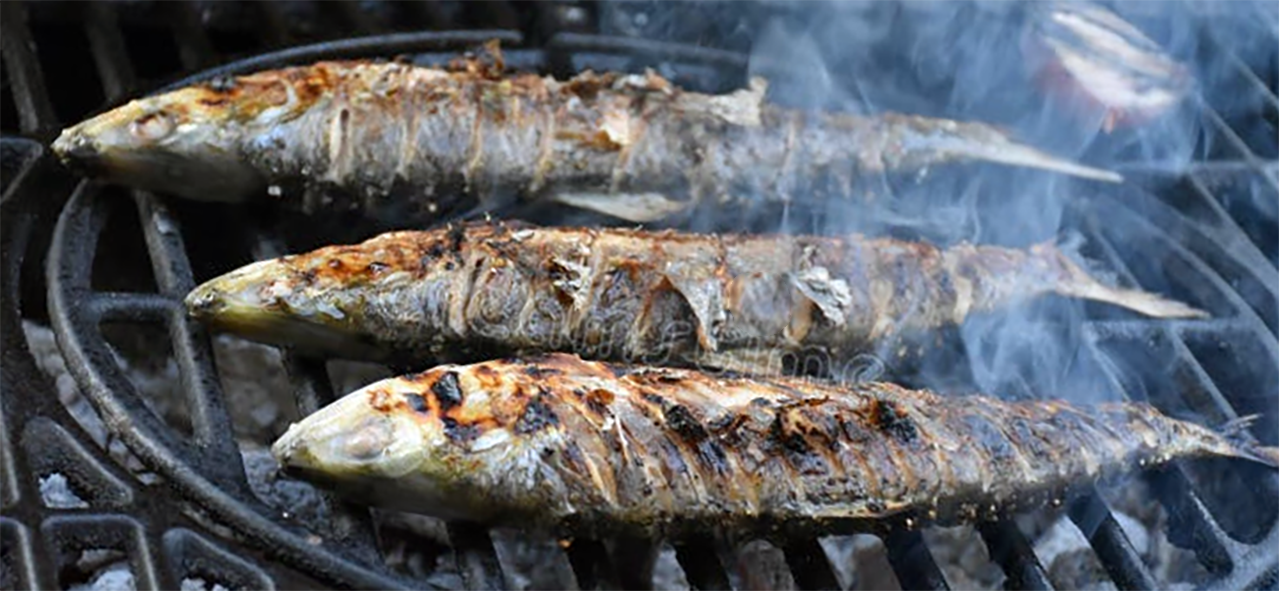 whole shad cooking on a barbecue