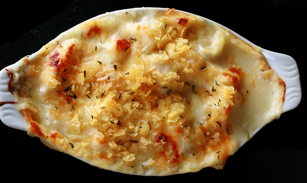 turbot au gratin in a white baking dish