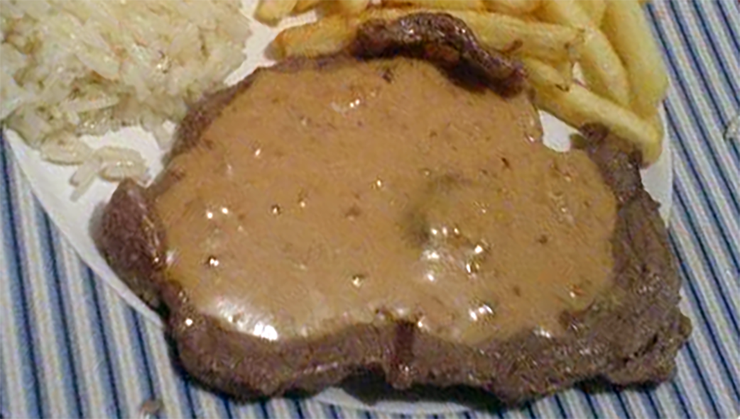 beef steak served topped with peanut sauce, dish from Mozambique