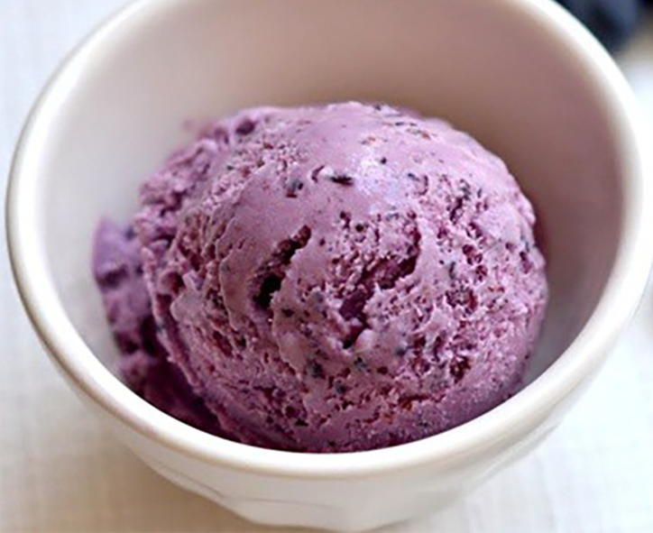 scoop of purple bilberry ice cream in a ramekin
