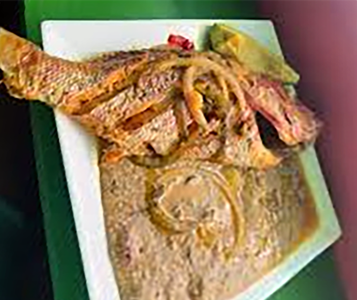 boiled fish served with hominy and avocado slices