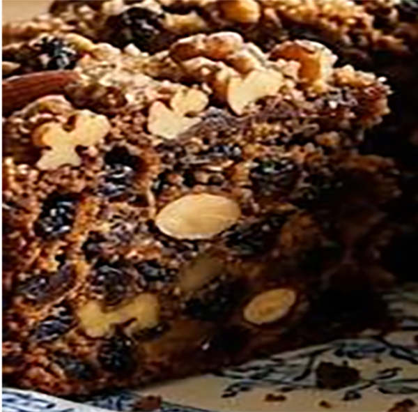 slice of nut-topped fruity ginger cake on a plate