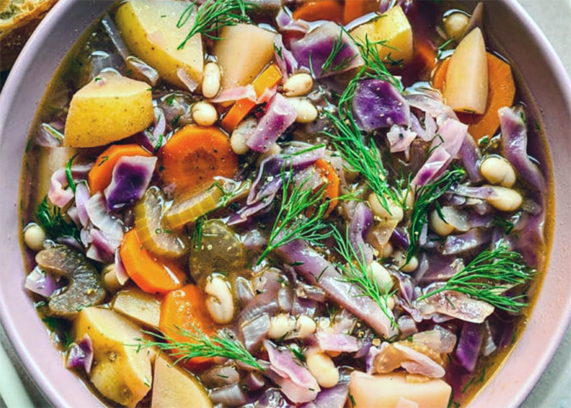 red cabbage based vegetable soup in a bowl