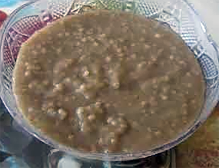 Togolese millet porridge served in a glass bowl