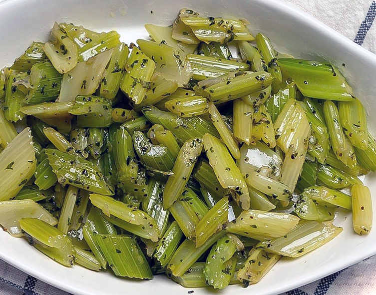 braised celery served in an oval baking dish