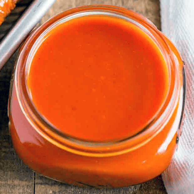 buffalo sauce for chicken wings in a jam jar