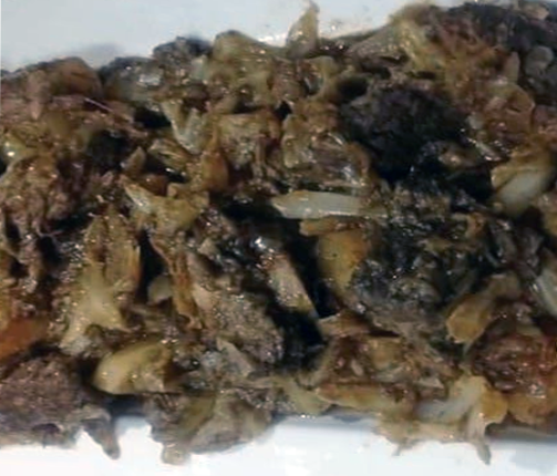 South African cabbage bredie spread on a white plate
