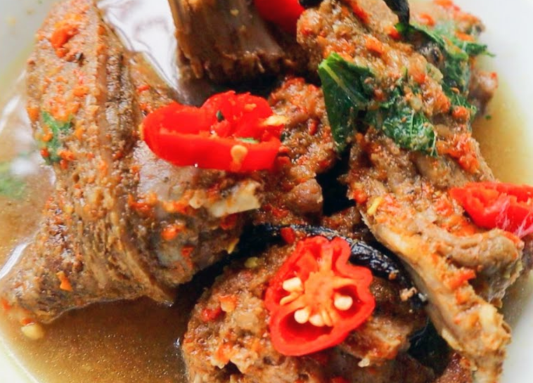 cane rat pepper soup served garnished with sliced hot chillies