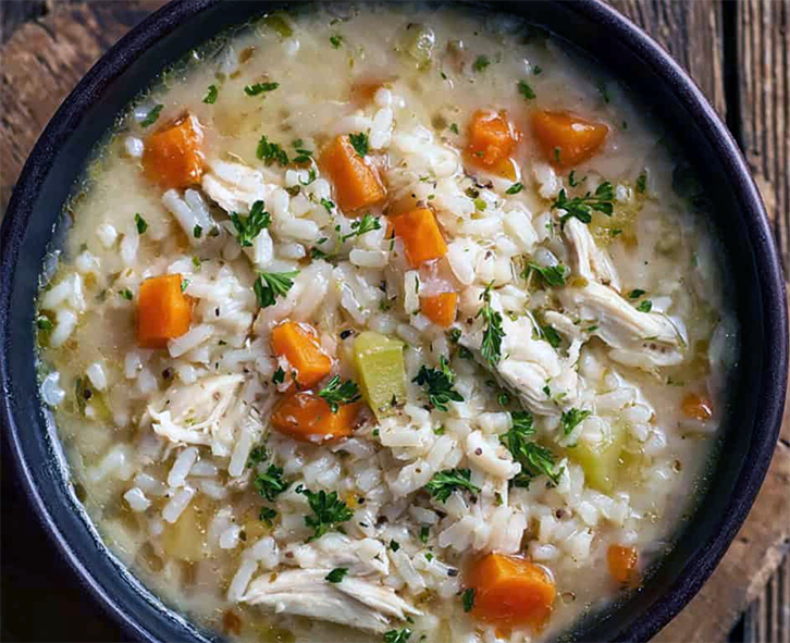 chicken and rice soup with vegetables in a soup bowl