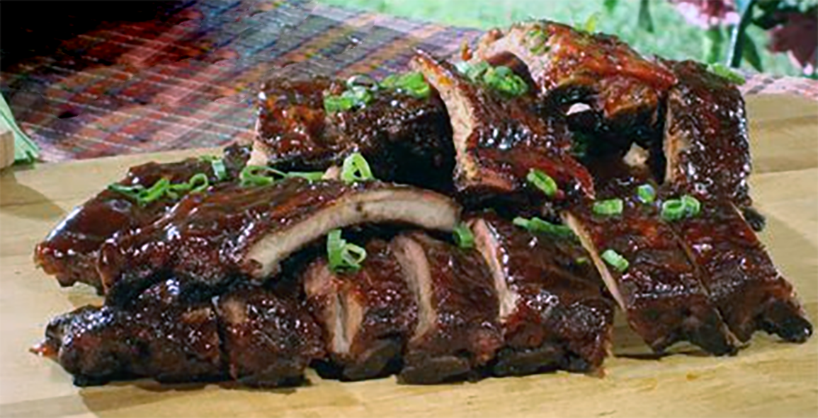 pile of Chinese-style barbecued pork ribs on a wooden board