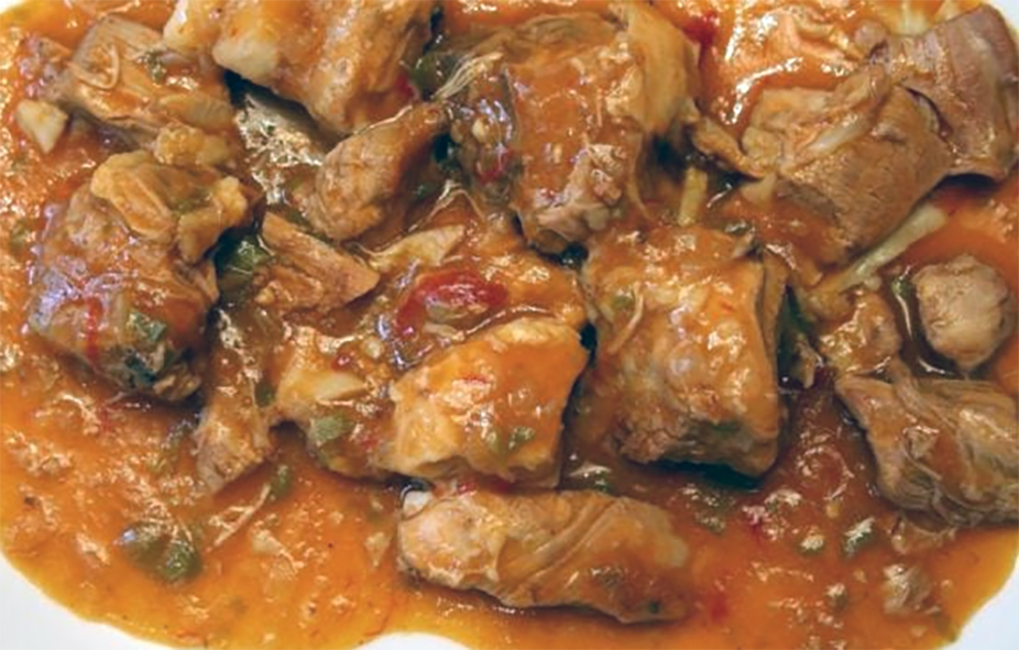 slow cooked stew of lamb in a tomato sauce with bell peppers on a plate