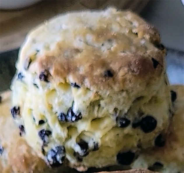 currant soda bread scone sitting on a pile of other scones
