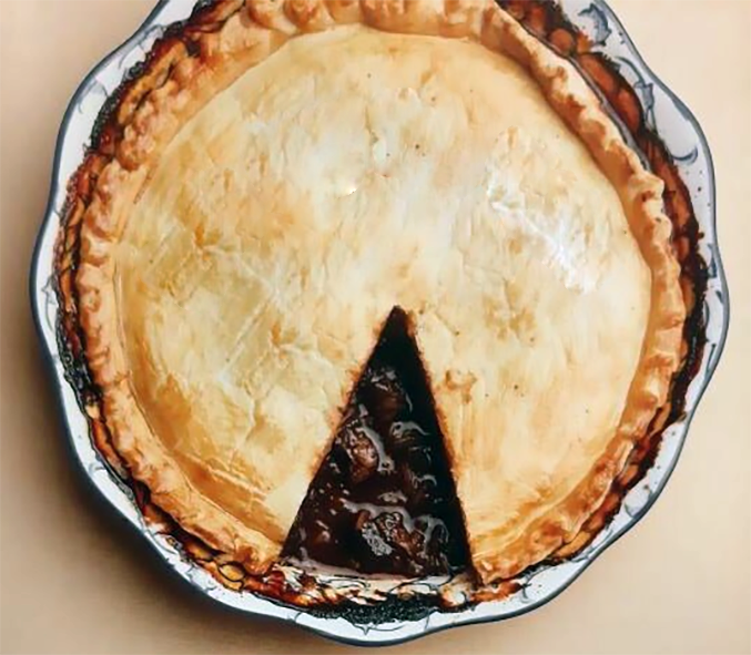 Dartmouth venison pie with a wedge removed to reveal the filling