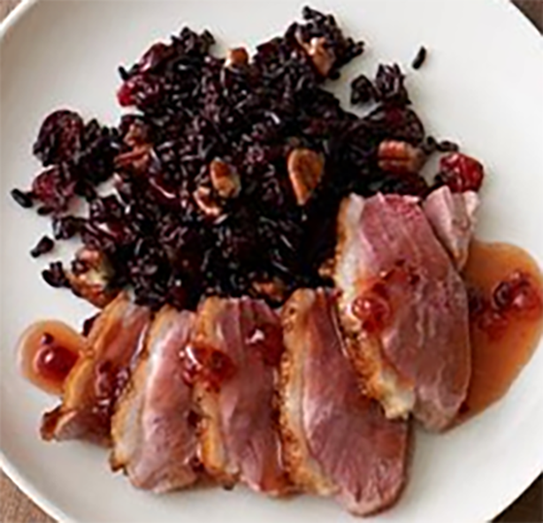 sliced pan-fried duck breasts served with sauerkraut and lingonberries