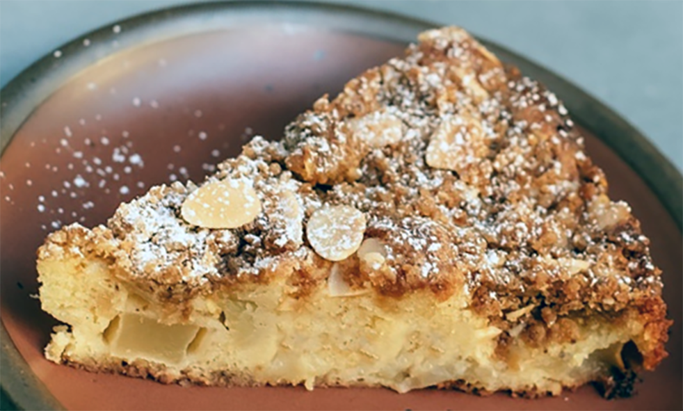 wedge of crockpot apple streusel cake on a plate