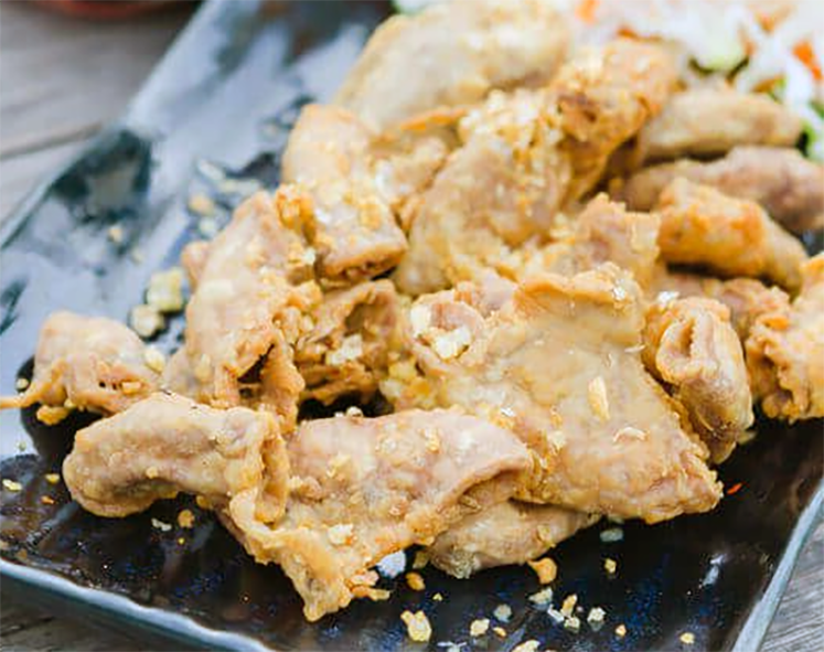 deep fried chitterlings or chitlins on a black plate