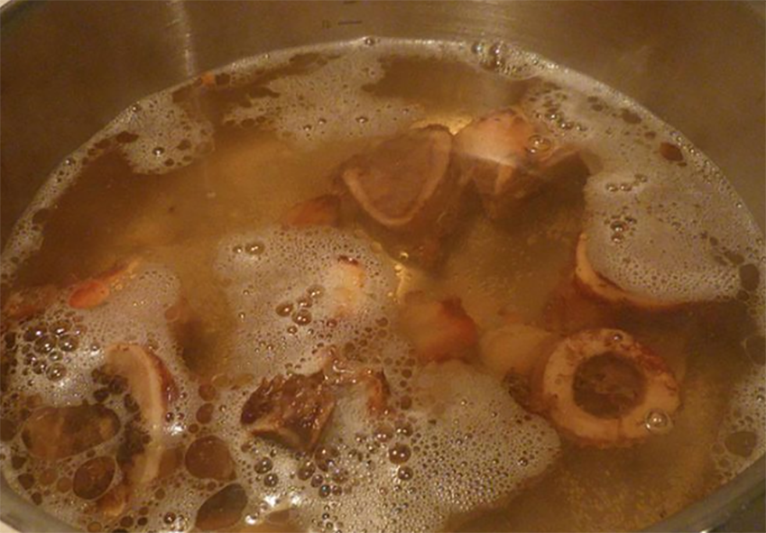 base game meat stock simmering in a stockpot