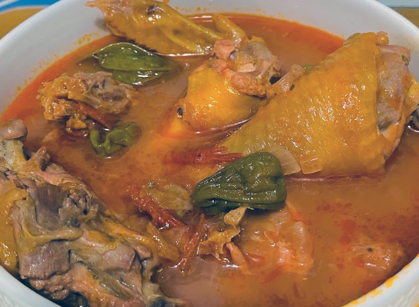 Gambian chicken pepper soup with green habaneros in a tomato base
