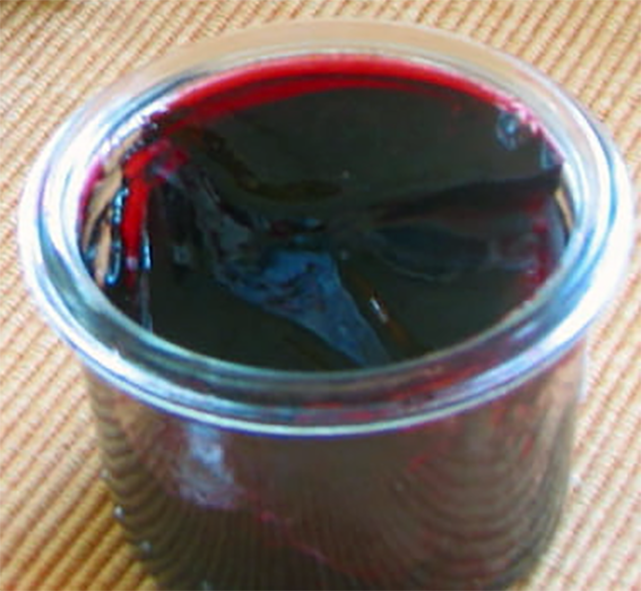 hibiscus flower jelly in a small glass jar