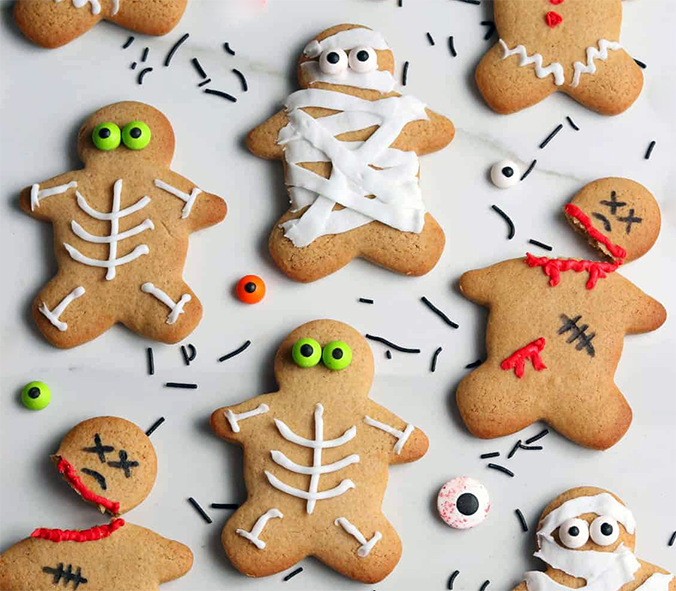 halloween gingerbread corpses on a lined baking tray