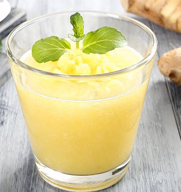 Gnamakoudji, Ivorian ginger drink served in a glass garnished with a sprig of mint