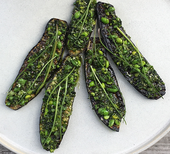 grilled courgette strips topped with sea plantains and peas