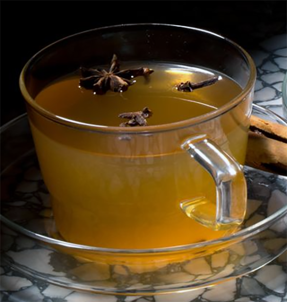 spiced mulled ginger ale punch in a glass cup